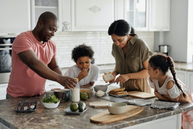 Family uses household goods products to cook a meal together in the kitchen.