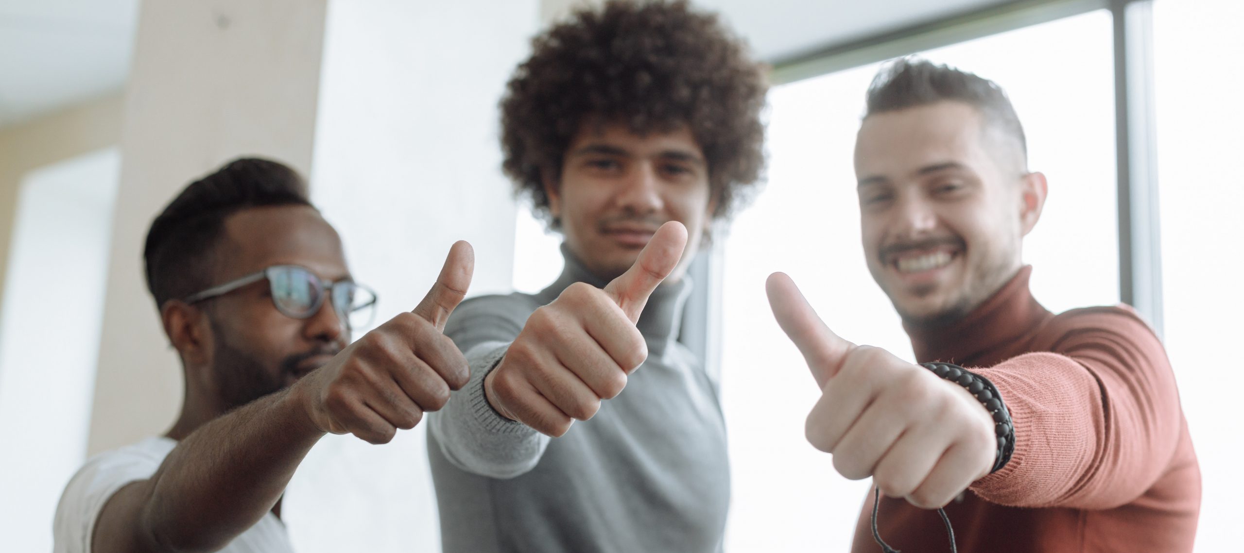 3 men giving a thumbs up for successful qualitative research